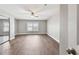 Spacious bedroom featuring wood-look flooring, a ceiling fan, and a bright window at 17 Bellevue Dr, Treasure Island, FL 33706