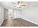 Bedroom with closet, ensuite bathroom, plantation shutters, fan, gray walls, and white trim at 17 Bellevue Dr, Treasure Island, FL 33706