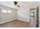 A bedroom with wood-look floors and window with plantation shutters at 17 Bellevue Dr, Treasure Island, FL 33706