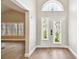 Bright entryway with decorative glass doors, an arched window and light hardwood floors at 17 Bellevue Dr, Treasure Island, FL 33706