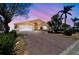 Beautifully landscaped home featuring a brick driveway and lush tropical greenery at 17 Bellevue Dr, Treasure Island, FL 33706