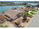 Beautiful waterfront home featuring a private dock, pool, and lush tropical landscaping at 17 Bellevue Dr, Treasure Island, FL 33706