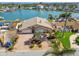 Inviting waterfront home with brick paver driveway, manicured lawn, and lush tropical landscaping at 17 Bellevue Dr, Treasure Island, FL 33706