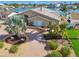 Inviting waterfront home with brick paver driveway, manicured lawn, and lush tropical landscaping at 17 Bellevue Dr, Treasure Island, FL 33706