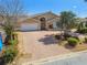Charming home featuring a brick paver driveway, lush landscaping, and a two-car garage at 17 Bellevue Dr, Treasure Island, FL 33706