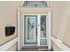 Elegant front door with decorative glass panels and a fresh, modern look at 17 Bellevue Dr, Treasure Island, FL 33706