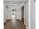 Inviting hallway featuring wood floors leading to an open living space with bright natural light at 17 Bellevue Dr, Treasure Island, FL 33706