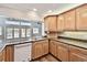 Bright kitchen featuring granite countertops, wood cabinets, and modern appliances overlooking the water at 17 Bellevue Dr, Treasure Island, FL 33706