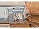 Granite countertops and stainless steel sink in a bright kitchen overlooking the great room and waterfront at 17 Bellevue Dr, Treasure Island, FL 33706