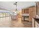 Spacious kitchen featuring an island, wood flooring and cabinets, with large windows for natural light at 17 Bellevue Dr, Treasure Island, FL 33706