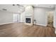 Living room features a fireplace, wood-look flooring, vaulted ceiling with fan, and recessed lighting at 17 Bellevue Dr, Treasure Island, FL 33706