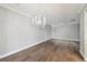 Open living area with a modern chandelier and crown molding details at 17 Bellevue Dr, Treasure Island, FL 33706