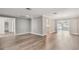 Open-concept living room with new hardwood floors and elegant chandelier at 17 Bellevue Dr, Treasure Island, FL 33706