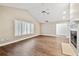 Bright living room with vaulted ceilings, fireplace, fan, and plantation shutters at 17 Bellevue Dr, Treasure Island, FL 33706