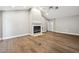 Bright living room with hardwood floors, a fireplace, high ceilings, and neutral paint at 17 Bellevue Dr, Treasure Island, FL 33706