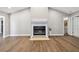 Bright living room with hardwood floors, a fireplace, high ceilings, and neutral paint at 17 Bellevue Dr, Treasure Island, FL 33706