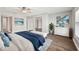 Cozy bedroom with shuttered windows, ample closet space and beach themed artwork at 17 Bellevue Dr, Treasure Island, FL 33706