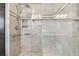 Modern shower with marble tiling, chrome fixtures, glass door, and built in bench at 17 Bellevue Dr, Treasure Island, FL 33706