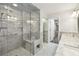 Luxurious marble shower with glass door, built-in bench, shelves, and chrome fixtures at 17 Bellevue Dr, Treasure Island, FL 33706