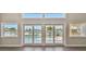 Living room with water views through multiple windows and doors overlooking the pool at 17 Bellevue Dr, Treasure Island, FL 33706