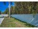Privacy-fenced yard featuring a mix of grass and turf, along with lush bamboo for added seclusion at 1710 Hibiscus N Cir, Oldsmar, FL 34677