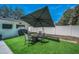 Inviting backyard features a fire pit with seating and sleek artificial turf, perfect for outdoor entertaining at 1710 Hibiscus N Cir, Oldsmar, FL 34677