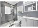 Modern bathroom features a glass enclosed shower, white vanity, and gray walls for a sleek design at 1710 Hibiscus N Cir, Oldsmar, FL 34677