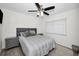 Bedroom with a queen bed, two nightstands, ceiling fan and a window allowing natural light to fill the space at 1710 Hibiscus N Cir, Oldsmar, FL 34677