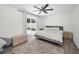 Bright bedroom features a ceiling fan, neutral color palette, and a sliding door leading to the backyard at 1710 Hibiscus N Cir, Oldsmar, FL 34677