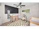 Cozy Bedroom with changing table, baby swing, a checkered rug and plenty of natural light from the window at 1710 Hibiscus N Cir, Oldsmar, FL 34677