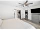 Spacious bedroom featuring a ceiling fan, a TV, a gray dresser, and access to other rooms at 1710 Hibiscus N Cir, Oldsmar, FL 34677
