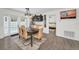 Elegant dining area with a modern chandelier, bar area, and view to the outdoor pool and bedroom at 1710 Hibiscus N Cir, Oldsmar, FL 34677