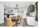 Bright dining room featuring a modern chandelier, beverage center, and access to the backyard and kitchen at 1710 Hibiscus N Cir, Oldsmar, FL 34677