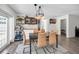 Chic dining space with a modern light fixture, beverage area, and view into a cozy bedroom space at 1710 Hibiscus N Cir, Oldsmar, FL 34677