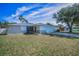 Charming single-Gathering home featuring a well-maintained lawn, a two-car garage, and beautiful landscaping at 1710 Hibiscus N Cir, Oldsmar, FL 34677