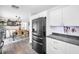 Stylish kitchen featuring stainless steel refrigerator and accents, and eat in dining area in the background at 1710 Hibiscus N Cir, Oldsmar, FL 34677