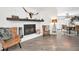 Cozy living space with a charming fireplace and comfortable seating, flowing into a dining area and kitchen at 1710 Hibiscus N Cir, Oldsmar, FL 34677