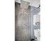 Sleek shower with rainfall shower head, and dark tile, and a shower niche for storage at 1710 Hibiscus N Cir, Oldsmar, FL 34677