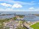 Expansive aerial showcases a scenic marina, stadium, and the waterfront cityscape against a blue sky dotted with fluffy clouds at 175 1St S St # 2603, St Petersburg, FL 33701