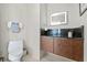 The bathroom features a modern lit mirror, stylish vanity, and toilet at 175 1St S St # 2603, St Petersburg, FL 33701