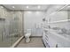 Modern bathroom featuring a glass-enclosed shower with stylish tile and marble countertops at 175 1St S St # 2603, St Petersburg, FL 33701