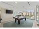 Well-lit billiard room featuring a pool table, TV, and city views from large windows at 175 1St S St # 2603, St Petersburg, FL 33701