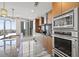 Modern kitchen featuring wood cabinets, granite countertops, and stainless steel appliances with city views at 175 1St S St # 2603, St Petersburg, FL 33701