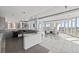 Bright lounge area featuring a bar with bar stools, tiled floors, and large windows at 175 1St S St # 2603, St Petersburg, FL 33701