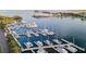 Aerial view of a waterfront marina with multiple slips accommodating an array of yachts and boats on a sunny day at 175 1St S St # 2603, St Petersburg, FL 33701
