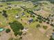 High altitude aerial view of expansive acreage featuring estate home and barn at 18423 Lithia Towne Rd, Lithia, FL 33547