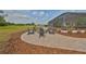 Backyard patio with fire pit and Adirondack chairs with a view of the beautiful greenery at 18423 Lithia Towne Rd, Lithia, FL 33547