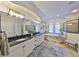 This bathroom features a double vanity, garden tub, walk-in shower with tile, and neutral walls at 18423 Lithia Towne Rd, Lithia, FL 33547