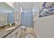 This bathroom has neutral walls, a single vanity, and a shower with a blue curtain at 18423 Lithia Towne Rd, Lithia, FL 33547
