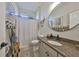 Bathroom featuring granite countertops, rustic decor, and modern round mirror at 18423 Lithia Towne Rd, Lithia, FL 33547